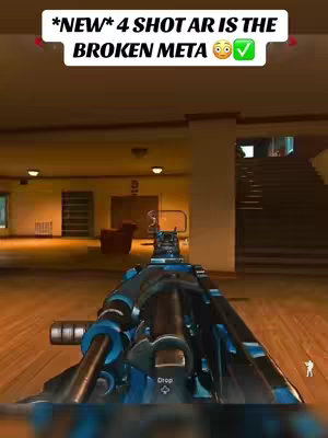The cover image shows the first-person view of a gun in a first-person shooter game. A text overlay at the top of the image reads "*NEW* 4 SHOT AR IS THE BROKEN META 😳✅". The weapon, a dark blue assault rifle, is in focus, with the background of a room in the game visible. There isn't a person visible in the image.