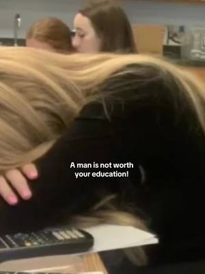The cover image shows a group of students in a classroom setting. The primary focus is on the backs of students as they lean together over what seems to be a desk. The color palette includes a mix of dark tones from clothing and the room, with hints of fair skin or light hair. In the foreground, there is a blurry close up of a black object that seems like a device of some sort. The text overlayed contains a motivating phrase.