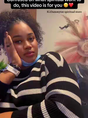 A woman with dark curly hair and fair skin is shown from the chest up, resting her head on her hand with a slightly sad expression. She's wearing a black and white striped sweater. Text overlays at the top and bottom indicate the video's content and an Instagram handle.