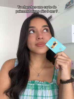 A person, presumably a young woman with long dark hair, is holding a credit card and looking upwards. The card has an image of a dog on it and is held near the person's lips, with one of her hands in front of her face as if deep in thought. Text is overlaid at the top of the image.