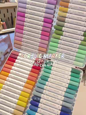 The cover image showcases various trays filled with colorful acrylic markers. The markers are neatly arranged in rows, displaying a wide range of colors. The layout of the image is organized and visually appealing. Text overlaid on the image reads "ACRYLIC MARKER" and "80 CÂY GIÁ RẺ".
