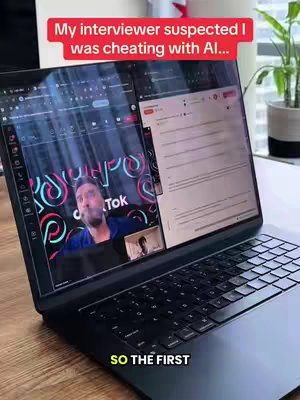 A laptop screen displays two windows: a video call with a man, and a document with text. Above, a red bar reads "My interviewer suspected I was cheating with AI...", setting a suspenseful tone.