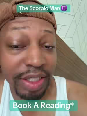 A close-up shot shows a Black man looking slightly to the side with a questioning expression. He is wearing a brown hat and a white tank top. Text overlays are visible, with a green banner at the top showing 'The Scorpio Man' and another green banner at the bottom that says 'Book A Reading'.