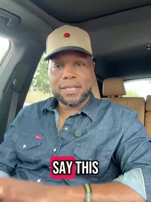 A man in a car wearing a baseball cap and a denim shirt has a text overlay that says, "SAY THIS."