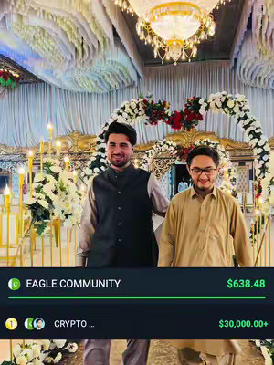 Two men stand in front of a decorated archway, possibly at a wedding or event, with floral arrangements and decorative lighting in the background. Text overlays are present at the bottom.