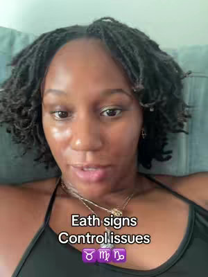 A close-up shot of a woman with dark, textured hair and a black top. Overlayed text reads 'Earth signs Control issues' above astrological symbols.