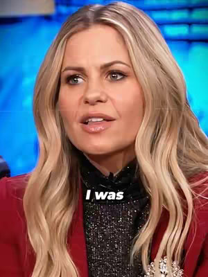 The cover image shows a medium shot of a woman with long blonde hair, red blazer, and a black top. The background is a blurry blue. Text overlayed on the image reads "I was". The woman is looking slightly off-camera, seemingly speaking.