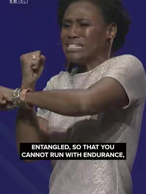 The image features a woman with dark skin, her facial expression suggests distress and potential crying. She is positioned against a blue background. The text overlay reads "ENTANGLED, SO THAT YOU CANNOT RUN WITH ENDURANCE." The woman wears a light-colored, short-sleeved top and bracelets on her left wrist.