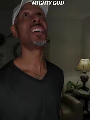 A man looks up with an open mouth in a medium shot, wearing a white cap and black shirt. Text overlayed at the top.