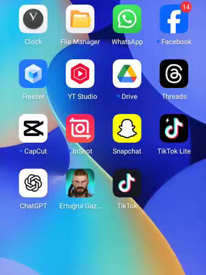 The cover image shows a smartphone screen displaying several app icons arranged in a grid format. The background is a gradient of blue and white colors. Several apps are visible, including the clock, file manager, WhatsApp, Facebook, Freezer, YT Studio, Drive, Threads, CapCut, InShot, Snapchat, TikTok Lite, ChatGPT, Ertuğrul Gazi, and TikTok. Overlaid over the layout are circular notifications.