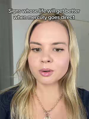 A woman with blonde hair and a gold necklace looks directly at the camera against an off-white background. Text overlayed on top reads, 'Signs whose life will get better when mercury goes direct.'
