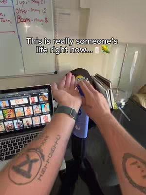 The cover image shows a first-person view of a person's arms and hands in a room. The person is applying a product from a blue bottle onto their hands. The background reveals a whiteboard with text and a laptop displaying images. Text overlayed in the image reads "This is really someone's life right now..." followed by an emoji of a block and an ear of corn.