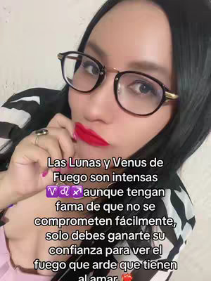 A woman with long black hair, wearing glasses and red lipstick, is looking directly at the camera. Text overlays the image in a vertical format