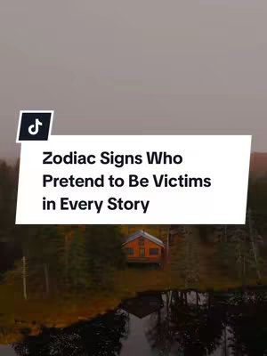 An aerial view of a serene lake is shown, with a backdrop of a forest and a cabin. Overlaid is a white rectangle containing the text: "Zodiac Signs Who Pretend to Be Victims in Every Story". The video is shared on the platform, indicated by the logo in the upper left corner.