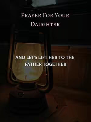The image shows a dimly lit scene with a vintage oil lamp in the foreground. Above the lamp in bold white text is the message "PRAYER FOR YOUR DAUGHTER". Below, in a similar font, it reads "AND LET'S LIFT HER TO THE FATHER TOGETHER", implying a religious or spiritual context. The background is dark, suggesting nighttime or a shadowed environment.