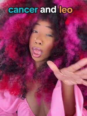 A close-up shot features a woman with a pink and red afro, a pink top, and an open mouth. The text "cancer and leo" in blue and orange is at the top-left corner of the image. The woman is looking at the camera with what appears to be a surprised expression.
