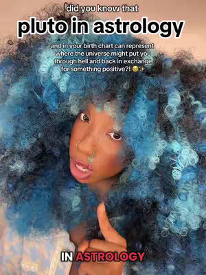 A selfie-style image features a person with dark skin, large, vibrant blue and light blue curly hair that seems to be an expansive wig, partially obscuring the background. The person is looking directly at the camera with their expression as if asking a question, with slightly parted lips. The lower part of their face and a finger is in focus along with the text overlay. The text and image use a mix of black and red. The image has a warm lighting that suggests a close-up of the face.