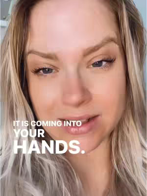 A close-up shot of a woman's face with blonde hair. The text overlayed in white is 'IT IS COMING INTO YOUR HANDS.'