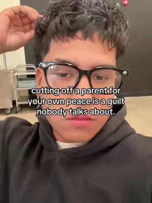 A close-up shot of a young person wearing glasses and a black hoodie, with text overlayed on the image.