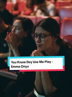 The cover image features two women in an auditorium setting, with one prominently in focus. The woman in focus wears glasses and appears to be emotionally moved, with tears visible. Overlaying the image is a white text box with the title and artist information.