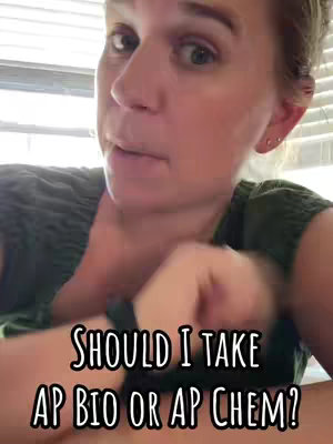 A woman in a green shirt is filming a video in what appears to be her home, with a window visible in the background. The video has superimposed text with a black outline that asks if she should take AP Bio or AP Chem.