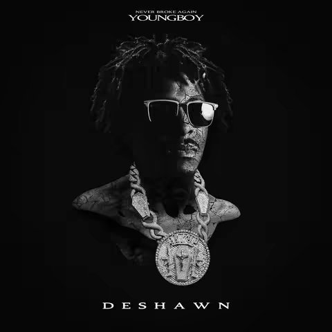 The image is a black and white album cover design featuring a bust of a person wearing sunglasses and a large pendant. The bust is stylized with a cracked texture overlay. At the top, the words 'NEVER BROKE AGAIN' and 'YOUNGBOY' are centered. The person's name, 'DESHAWN', is at the bottom. The overall composition is monochromatic, emphasizing the artist's image.