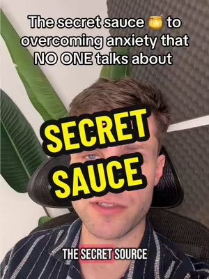 A man with short brown hair and blue eyes is centered in a selfie-style video image. Overlayed text reads "The secret sauce to overcoming anxiety that NO ONE talks about" in a sans-serif font. The words "SECRET SAUCE" are prominently displayed in a bold, yellow font with a black background. Underneath, "THE SECRET SOURCE" is displayed in a smaller banner also in all capital letters. The background includes green leaves and what appears to be a gray wall.