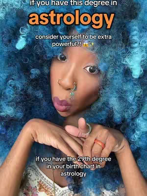 A selfie with a female creator with blue curly hair, posing and looking towards the camera. Decorative text overlays feature astrology-related insights. The background is a light tone color.