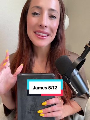 A woman is featured from the chest up, smiling and looking towards the camera. She is holding a Bible in her hands, with a microphone positioned in front of her. The background is blurred, and a text overlay displays the verse 'James 5:12.'