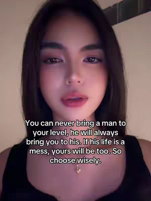 A close-up shot of a woman with long dark hair smiling softly, a text overlay with a relationship-related quote.  The woman is wearing a dark top, and a subtle gold necklace is visible.