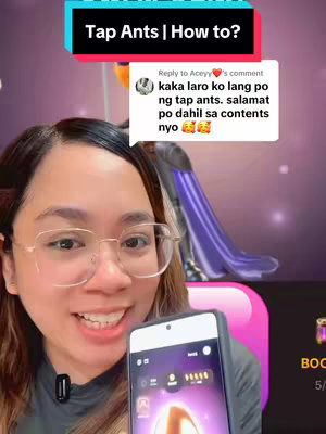 A woman with glasses holds a phone showing a game interface, overlaid by text and a comment bubble. The background is blurred with purple and a decorative element.
