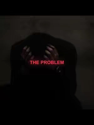 A dark, vertical image featuring a person with their head in their hands, obscuring their face. The text overlay indicates 'THE PROBLEM' in a bright red, positioned centrally and strikingly.