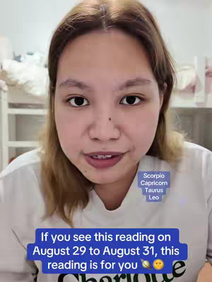 A centered close-up shot of a person's face. The person has light skin, medium-length brown hair, and is wearing a white t-shirt. Overlayed text boxes are at the top right and bottom center of the image. The top text box indicates the zodiac signs: Scorpio, Capricorn, Taurus, and Leo. The lower text box reads "If you see this reading on August 29 to August 31, this reading is for you."