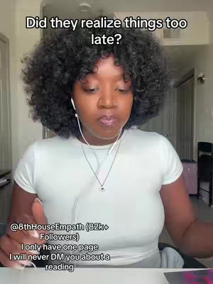 A medium shot features a Black woman with dark, curly hair. She wears a white t-shirt and has white earbuds in her ears. The background is slightly blurred, but appears to be an indoor setting. The image has text overlay at the top and the bottom. The overall composition is simple, centered on the woman.