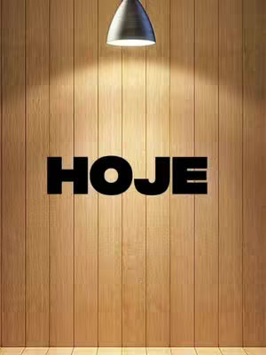 Image features a wooden panel background with vertical planks. Centered on the wall is the bold black word "HOJE", which means "TODAY" in Portuguese. A silver-colored ceiling lamp appears at the top center, casting a spotlight on the wall, with the word HOJE lying in the bright area.