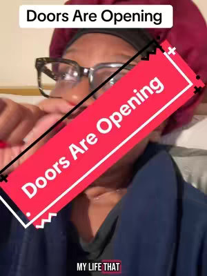 A close-up shot of a person wearing glasses and a burgundy head covering. A red rectangle with the text "Doors Are Opening" is diagonally overlaid across the person's face.