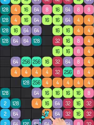 A colorful screenshot from a mobile puzzle game is shown. The game board is filled with numbered bubbles. At the bottom right side, there is a hand interacting with the game board.