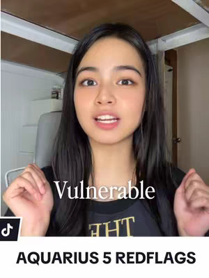 A young woman with black hair is centered in the frame, looking at the camera and talking. The text overlayed on the image reads "Vulnerable" with text below that reads "AQUARIUS 5 REDFLAGS". She is positioned in a room with a simple background.