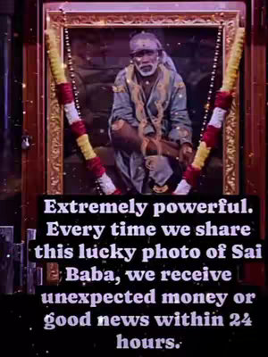 The image features a framed picture of a spiritual figure, Sai Baba, with garlands draped on either side. Below the frame, text is overlaid on a dark background. The overall composition is vertical, with colors ranging from gold and red to muted tones in the central portrait.