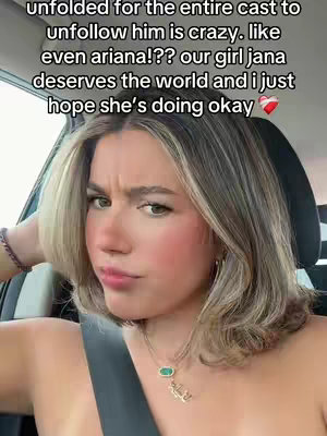 A young woman with light brown hair and highlights is seated inside a car, angled towards the camera. She has a partially visible necklace and a bracelet on her wrist. The woman's expression is slightly furrowed, with her head resting on her hand, as if in contemplation. Text is layered over the image. The lighting seems natural, suggesting an outdoor setting.