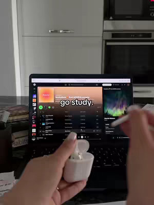 The cover image shows a woman holding an open case with white ear buds while setting in front of an open laptop. The laptop screen displays a Spotify playlist.