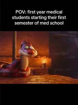 The still image shows a cartoon snake in a dimly lit setting, likely a room, with a wooden floor and a wall made of stone. The snake is the focal point, positioned on the left side, appearing to be gazing toward the right. The snake has a pinkish-red head with a white face and visible, colorful details, green eyes. The background is intentionally blurred, drawing attention to the snake, The lighting is warm, possibly from a candle and adds to the room scene.