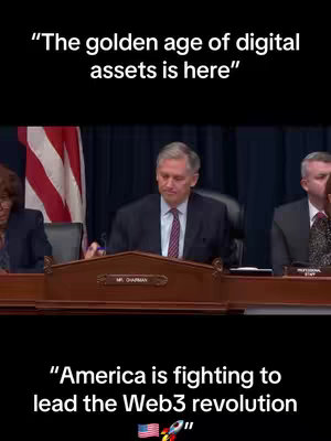 The cover image shows a panel of individuals seated behind a table, with a U.S. flag visible in the background on the left. Above the panel are overlaid two lines of white text. The bottom part of the image also contains white text with an American flag and a rocket ship.