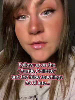 A close-up shot of woman's face, with fair skin, makeup, and long brown hair framing her face against a blurred background. She has prominent eye makeup (white eyeliner) and light pink lipstick.