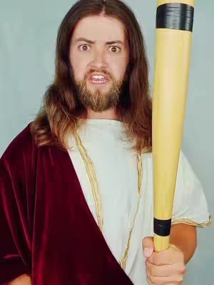 A man dressed as Jesus, holding a baseball bat with an angry expression.