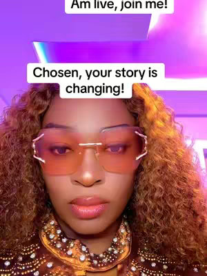 A close-up shot of a woman wearing large, stylish sunglasses. She has curly brown hair, and a golden-colored top. There is a gradient background with shades of purple. Text overlays read "Am live, join me!" and "Chosen, your story is changing!"