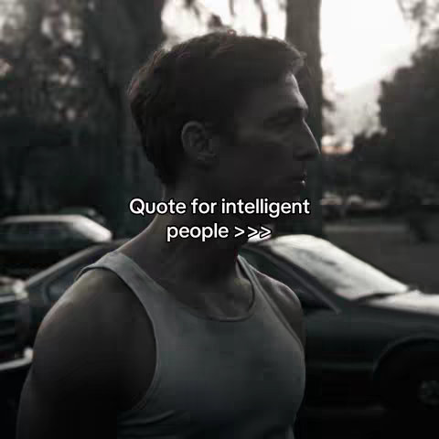 The cover image features a man in a white tank top, seen in profile and slightly from the side, in a moody, potentially outdoor setting. The background includes partially visible vehicles, suggesting a street or parking lot with trees in the blurred background. The lighting appears soft, creating shadows that define the man's features and physique. Text overlaid in white reads, "Quote for intelligent people >>>".