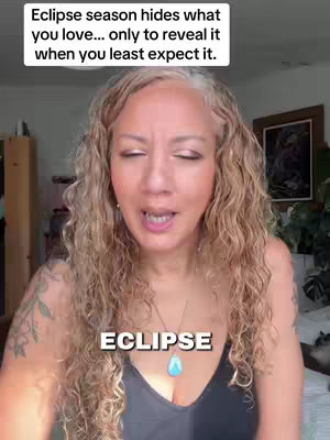 A woman with long curly blonde hair and a black top is centered in the frame. Overlaying the image is white text at the top with a message about eclipse season. At the bottom in the center, "ECLIPSE" in white text.