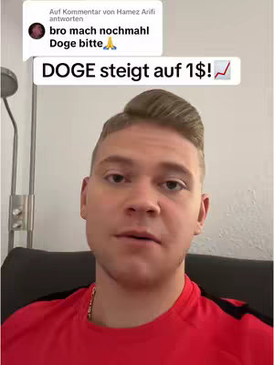 A man is centered in the frame, slightly angled. He is wearing a red shirt and a gold necklace. Above him, a comment thread by a sender that says “bro mach nochmahl Doge bitte” (bro do again Doge please) and a speech bubble above the man says in larger text: "DOGE steigt auf 1$"! (DOGE rises to $1!), with an upward trending arrow.