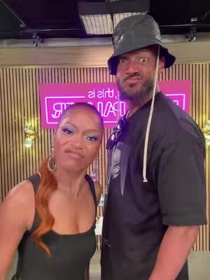 The cover image features Keke Palmer and Marlon Wayans standing close together, with both making exaggerated facial expressions. Keke is on the left, wearing a black top and has her hair in an orange tint. Marlon, on the right, is wearing a black bucket hat and a black shirt. Behind them is a pink neon sign that is partially visible. The background suggests a studio setting with wooden paneling.